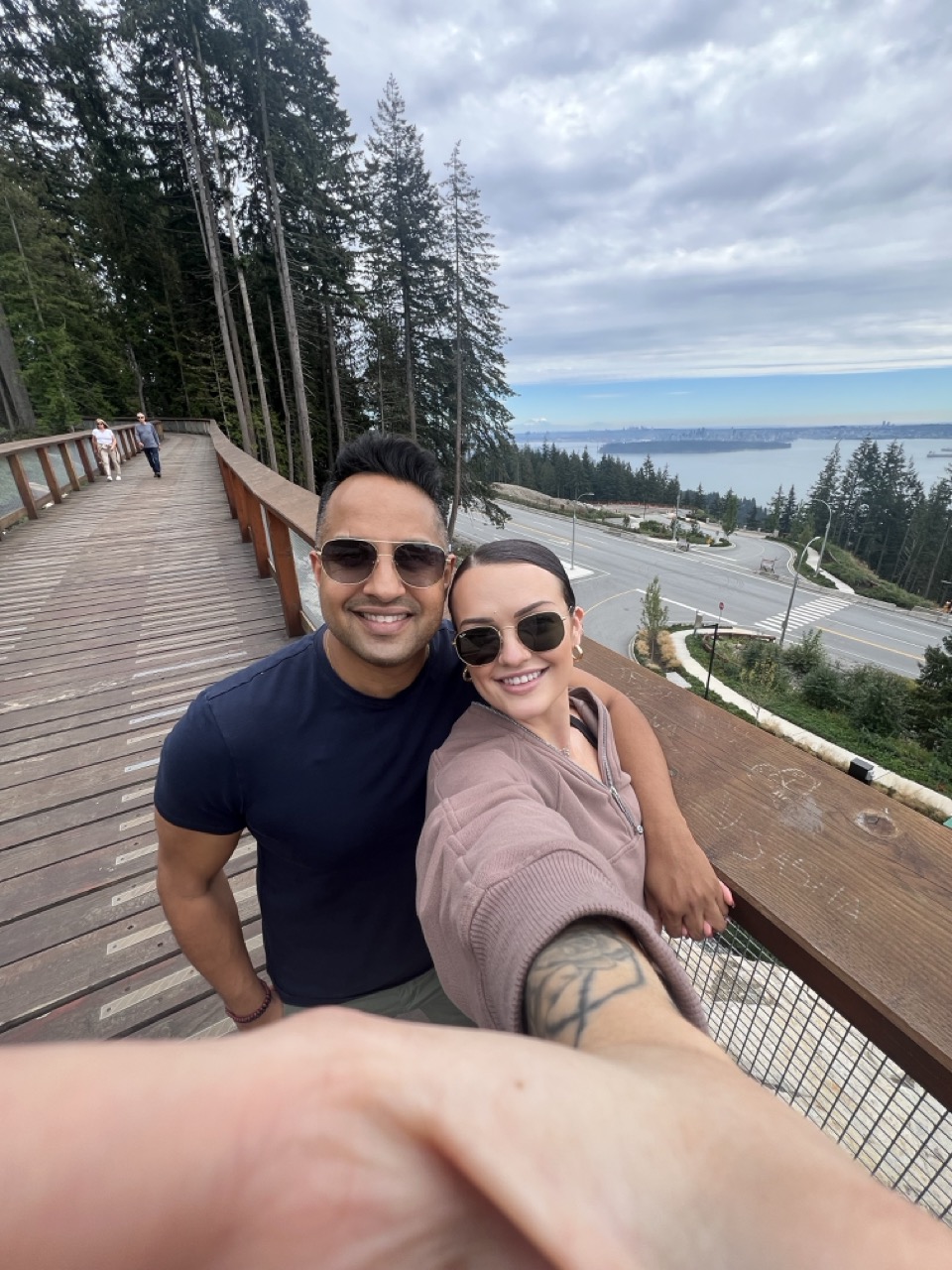 Brynn and Manoj on the Cypress Mountain boardwalk overlooking Vancouver